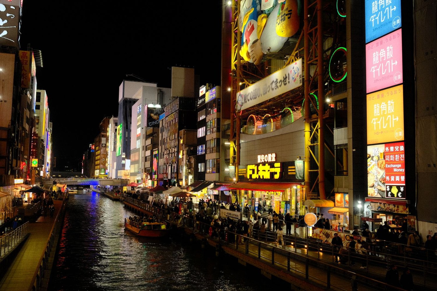 The Dotonbori canal at night, neon signs and the Glico runner reflected in the water