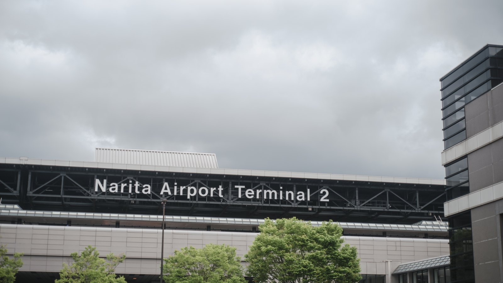 Departure hall at Narita Airport with check-in counters and flight boards